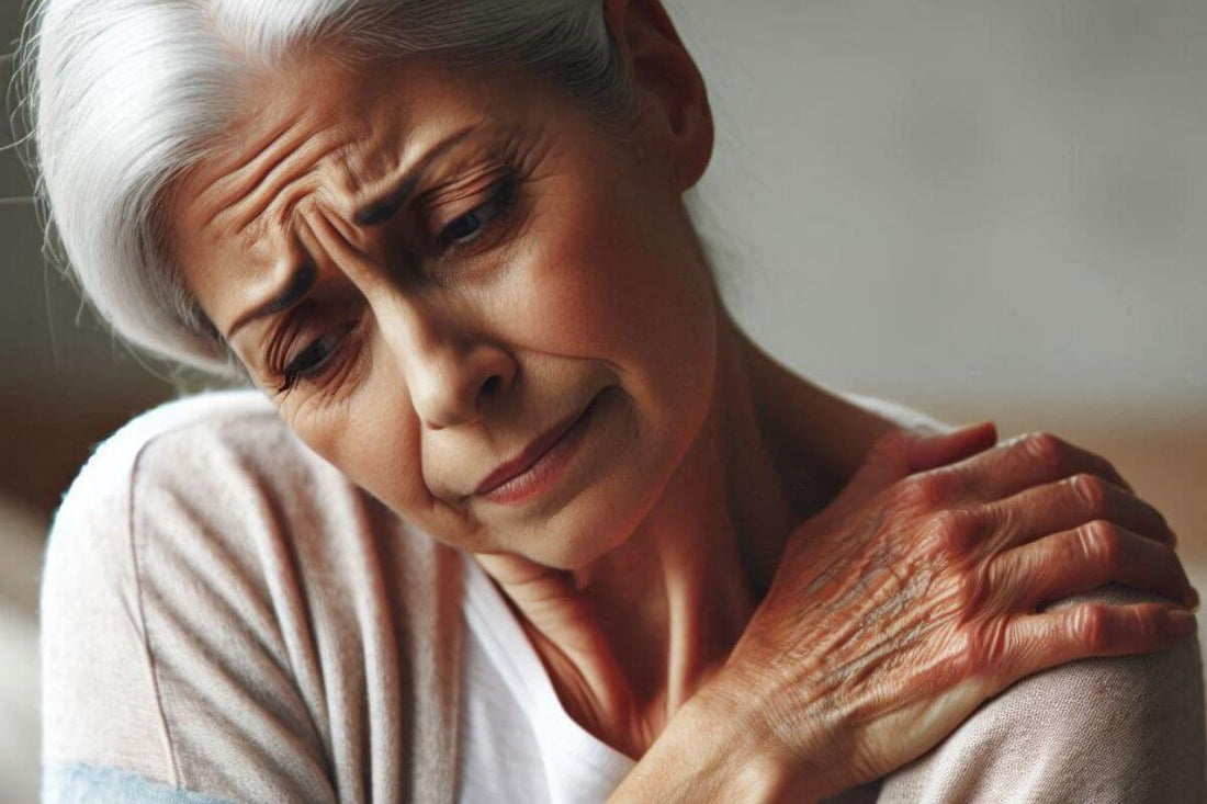 Older woman holding her shoulder