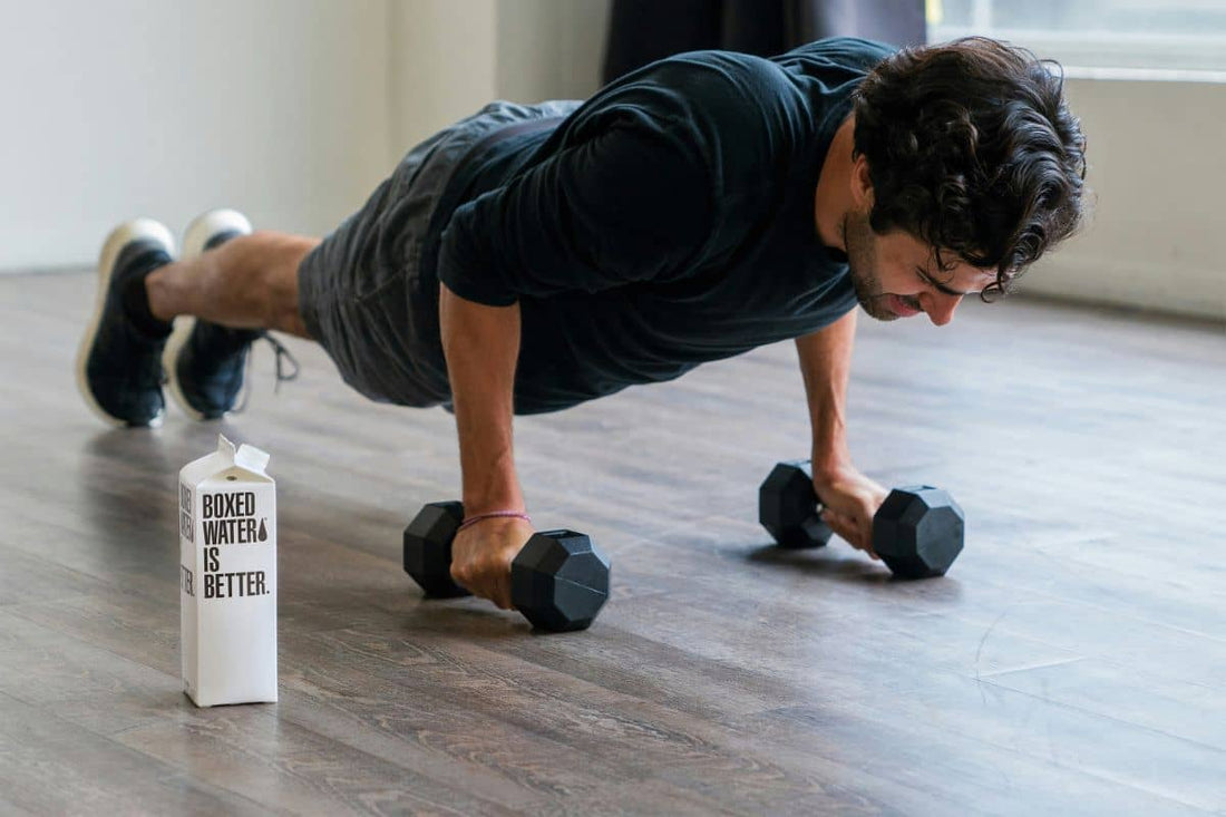 A man performing push-ups on a wooden floor