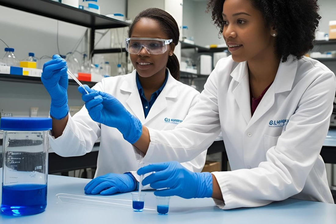 Two women in lab coats and gloves working in a laboratory with methylene blue