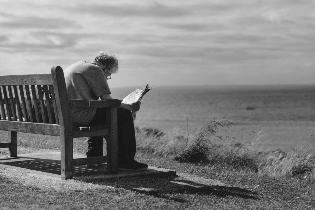 A man sitting on a park bench after taking methylene blue
